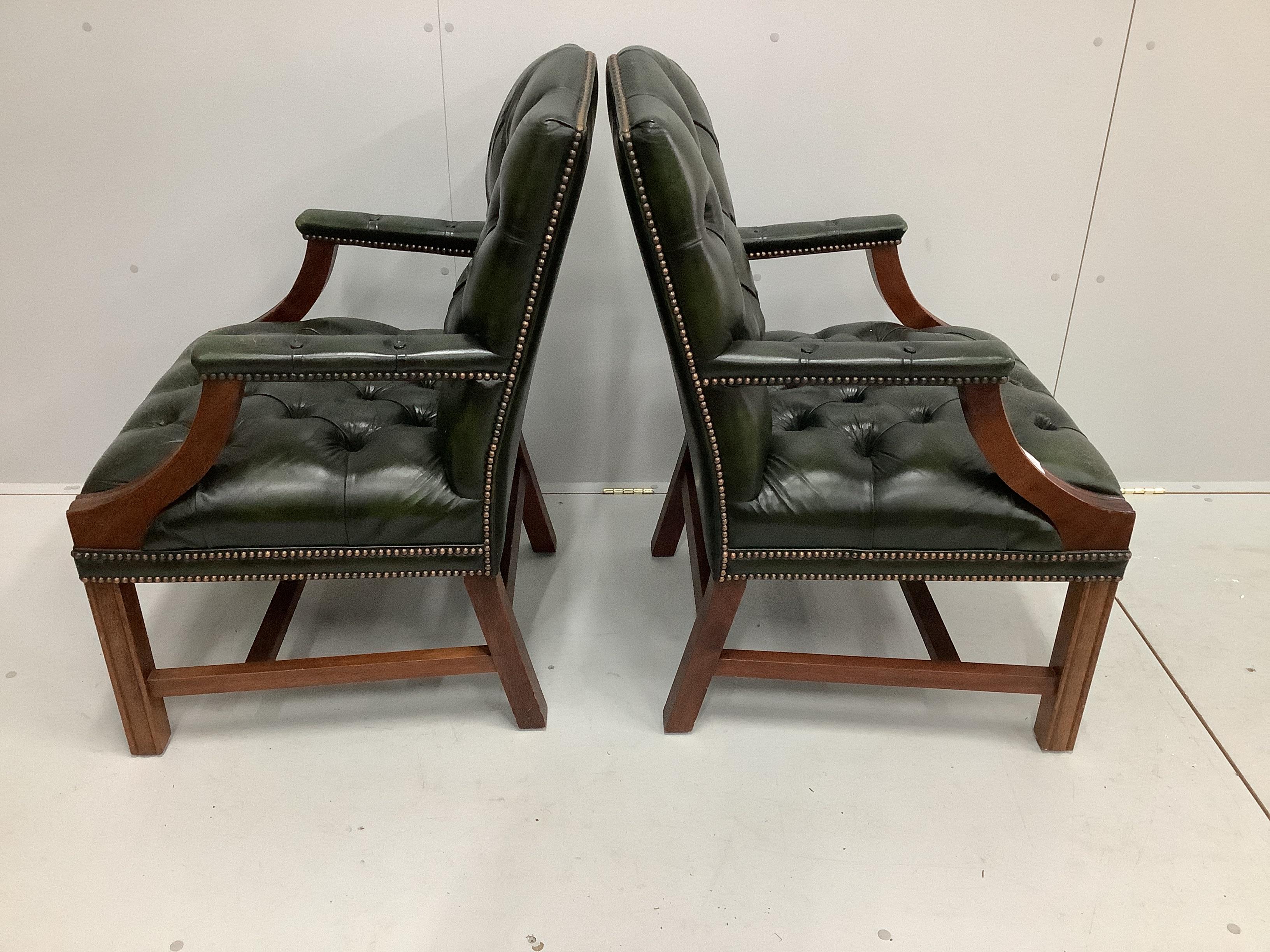 A pair of reproduction Gainsborough style buttoned green leather elbow chairs, width 63cm, depth 54cm, height 91cm